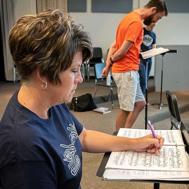 Closeup of MA in Music student taking notes